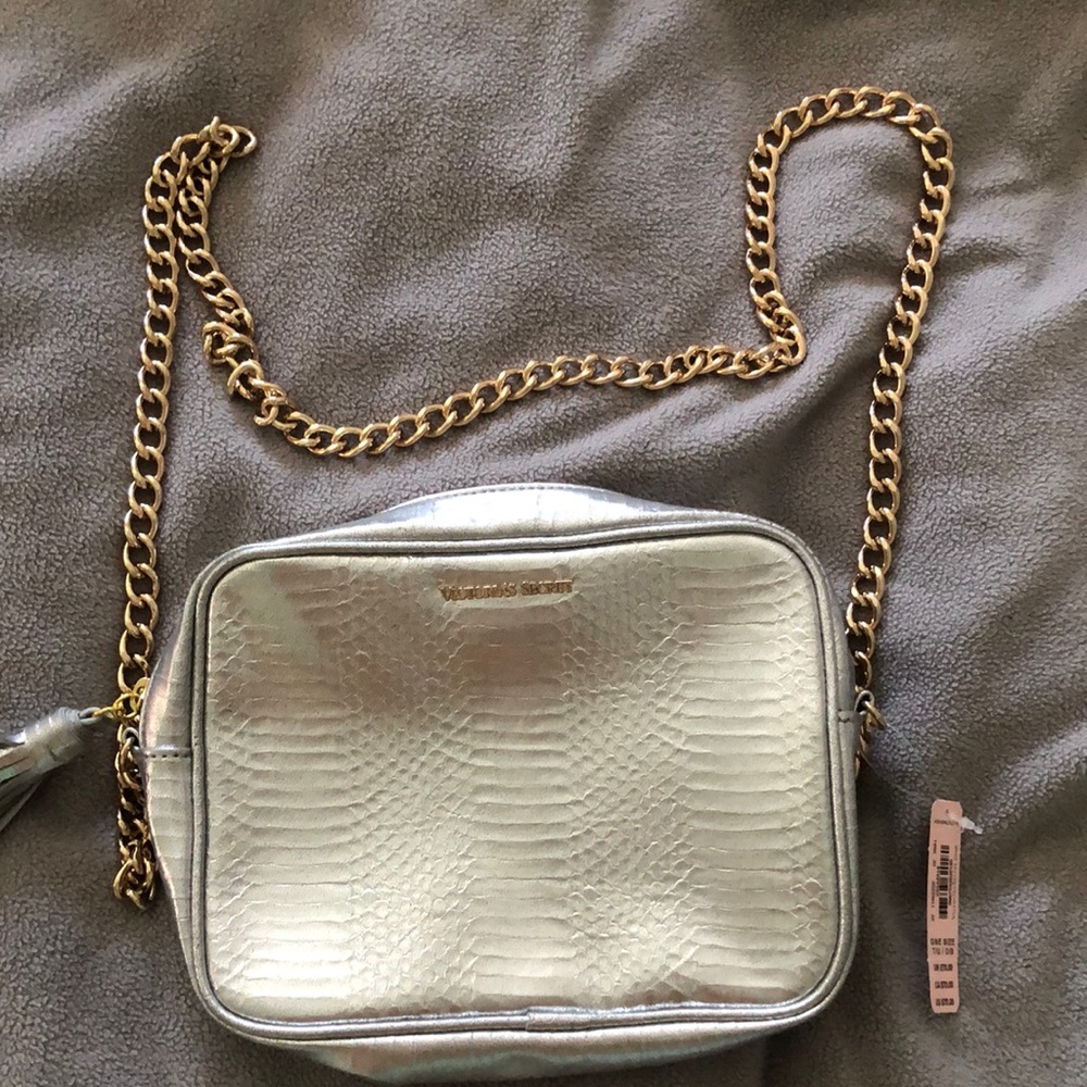 Victoria secret silver purse with gold chain and silver tassel.